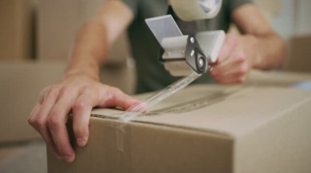 Rolling a tape on shipping box