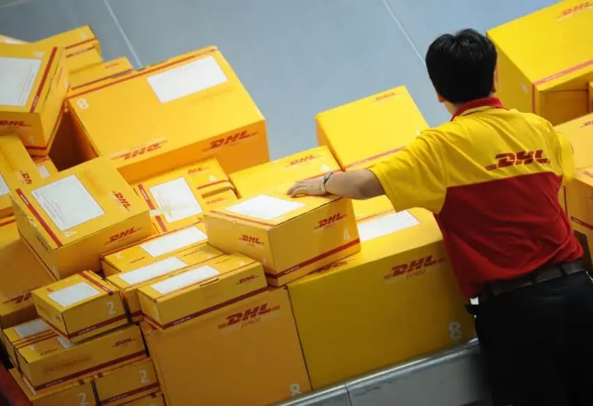A man is arranging DHL packages