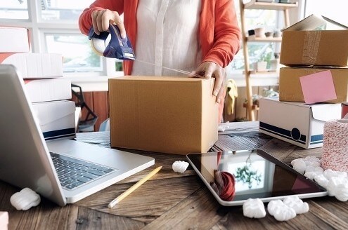 Man is measuring weight and dimensions of the box