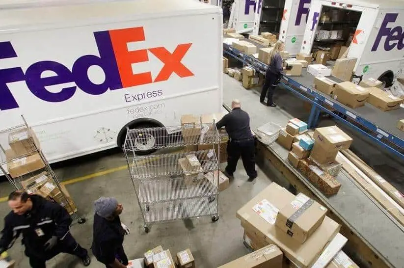 FedEx Scheduled Delivery Pending: People are organizing packages in warehouse