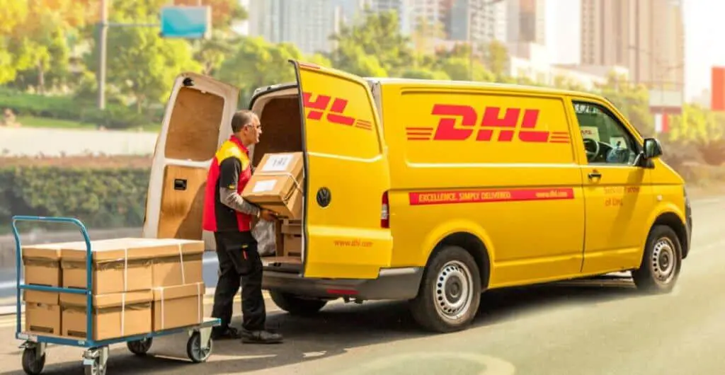 A man loading parcels in DHL van: DHL DELIVERY HOURS