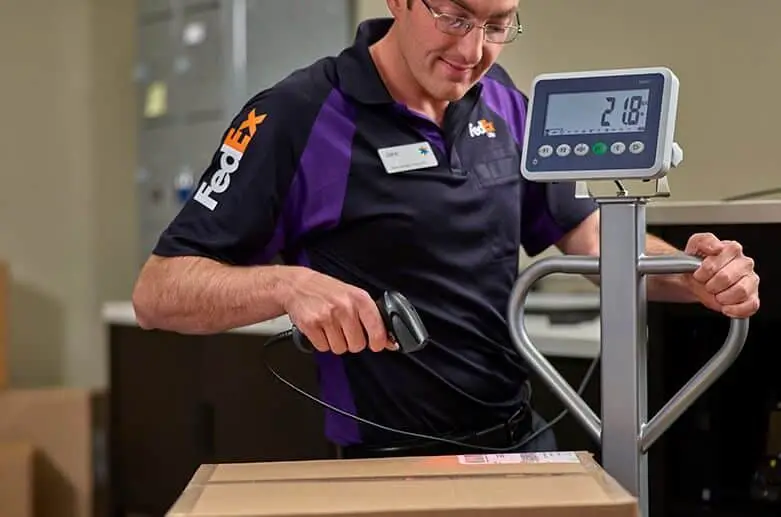 The man is scanning a fedex package