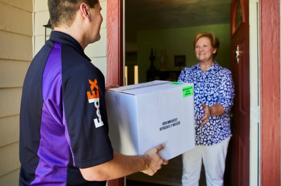 The man is delivering a package to woman