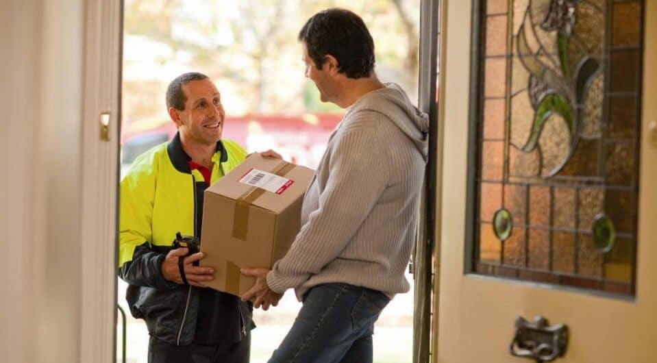 A courier man is delivering the parcel box